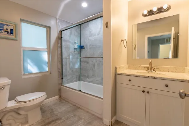 a bathroom with a toilet sink and shower