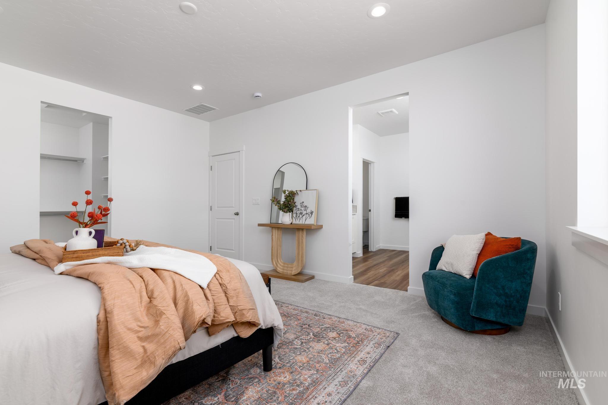 6049 West Snow Currant Street Meridian, ID 83646 - Photo 8 of 12 Carpeted bedroom with a spacious closet and recessed lighting