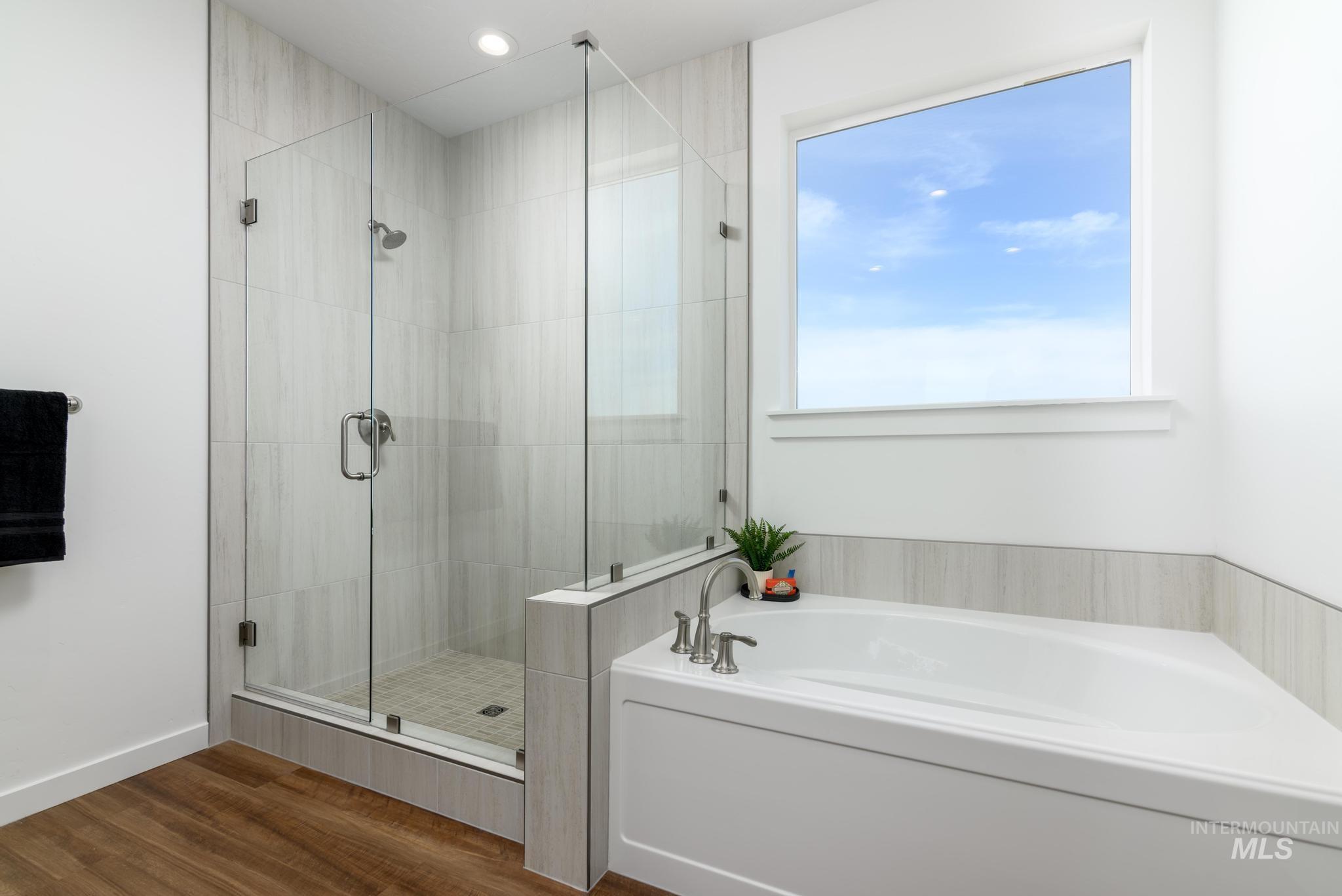 6049 West Snow Currant Street Meridian, ID 83646 - Photo 10 of 12 Full bathroom with a stall shower, a bath, dark wood-type flooring, and recessed lighting