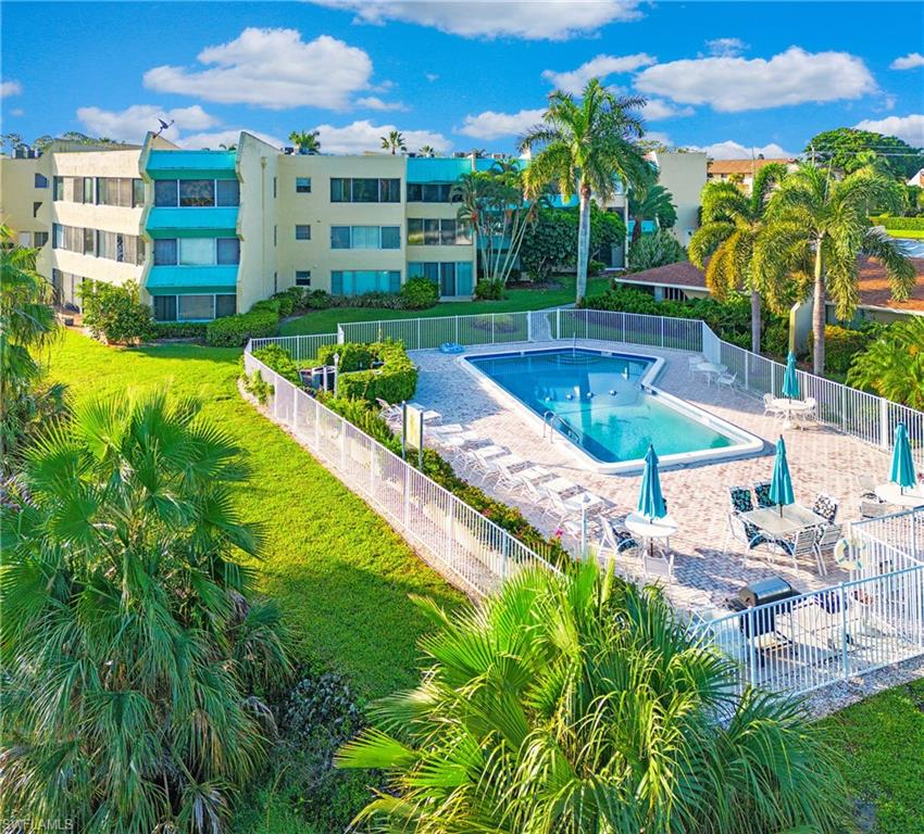 955 Palm View Drive, Unit B307 Naples, FL 34110 - Photo 1 of 25 a view of a swimming pool with a patio