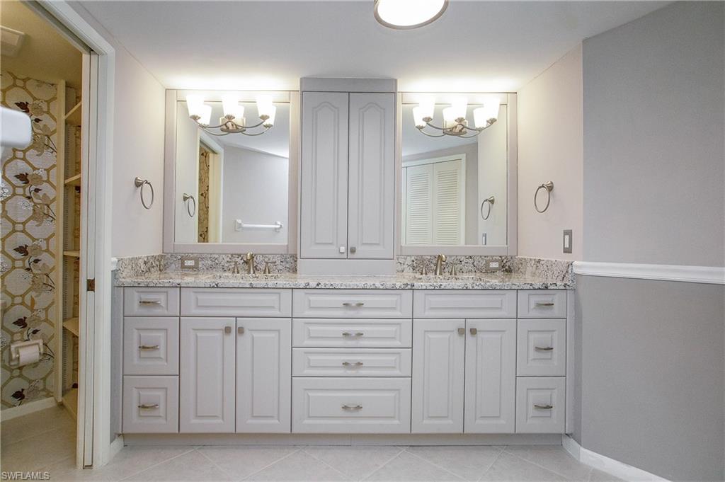 955 Palm View Drive, Unit B307 Naples, FL 34110 - Photo 18 of 25 a bathroom with a granite countertop sink double and mirror