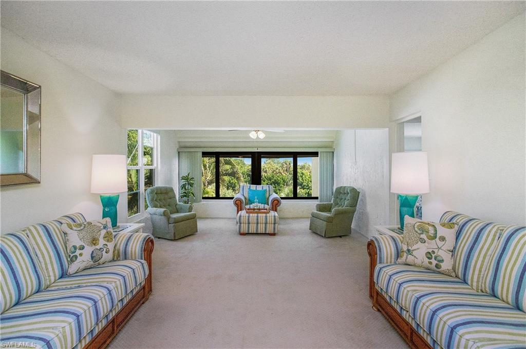 955 Palm View Drive, Unit B307 Naples, FL 34110 - Photo 5 of 25 a living room with furniture and floor to ceiling windows