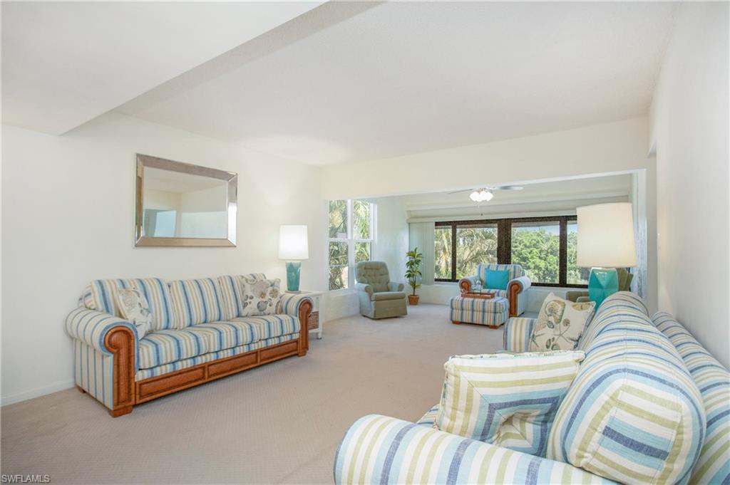 955 Palm View Drive, Unit B307 Naples, FL 34110 - Photo 6 of 25 a living room with furniture and a large window