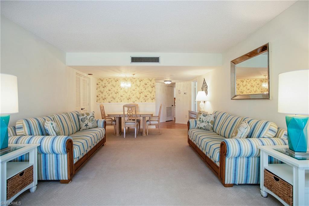 955 Palm View Drive, Unit B307 Naples, FL 34110 - Photo 7 of 25 a living room with furniture and a large window