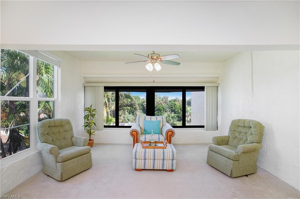 955 Palm View Drive, Unit B307 Naples, FL 34110 - Photo 8 of 25 a living room with furniture and a large window