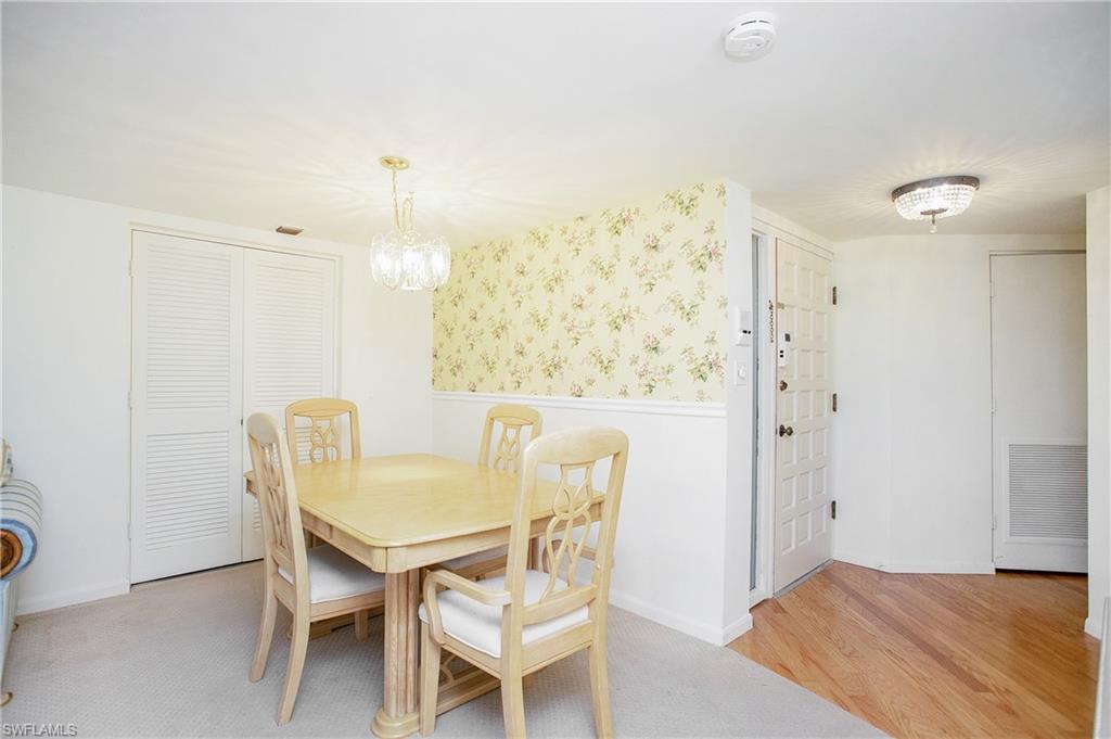 955 Palm View Drive, Unit B307 Naples, FL 34110 - Photo 10 of 25 a view of a dining room with furniture and wooden floor