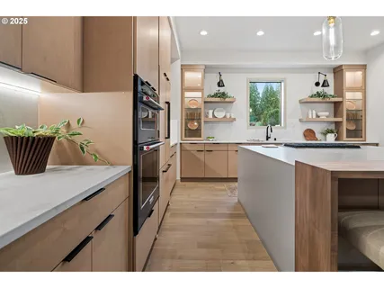 a kitchen with kitchen island a sink appliances and cabinets