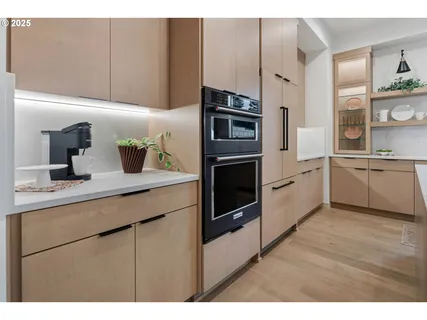 a kitchen with stainless steel appliances a sink a stove and cabinets