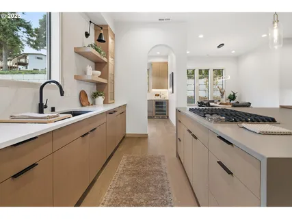 a kitchen with sink stove and cabinets