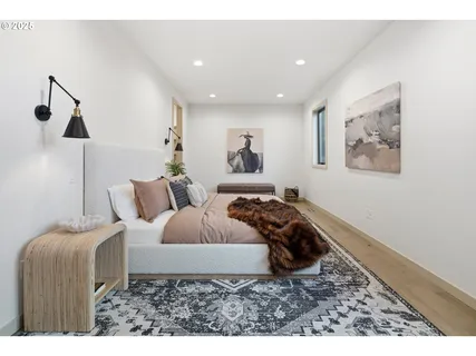 a bedroom with a bed and a painting on the wall