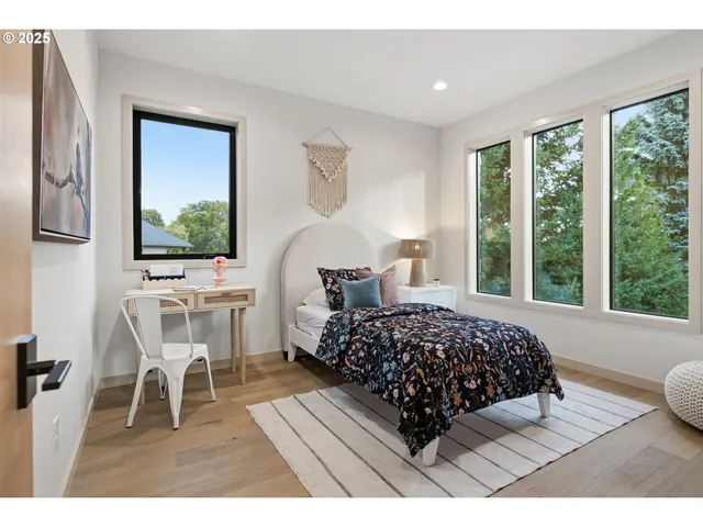 a living room with a bed furniture and a window