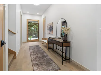a living room with a table and windows