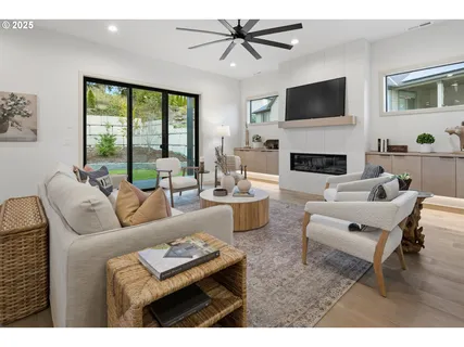 a living room with furniture a fireplace and a flat screen tv