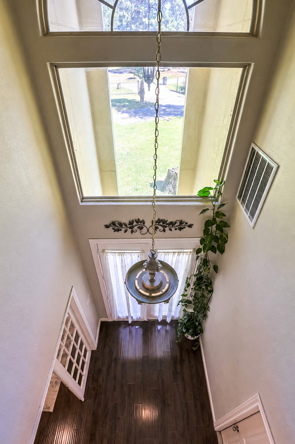 30119 West Geneva Drive Spring, TX 77386 - Photo 5 of 35 Dramatic two-story entry featuring a statement chandelier and large picture windows that fill the space with sunlight.