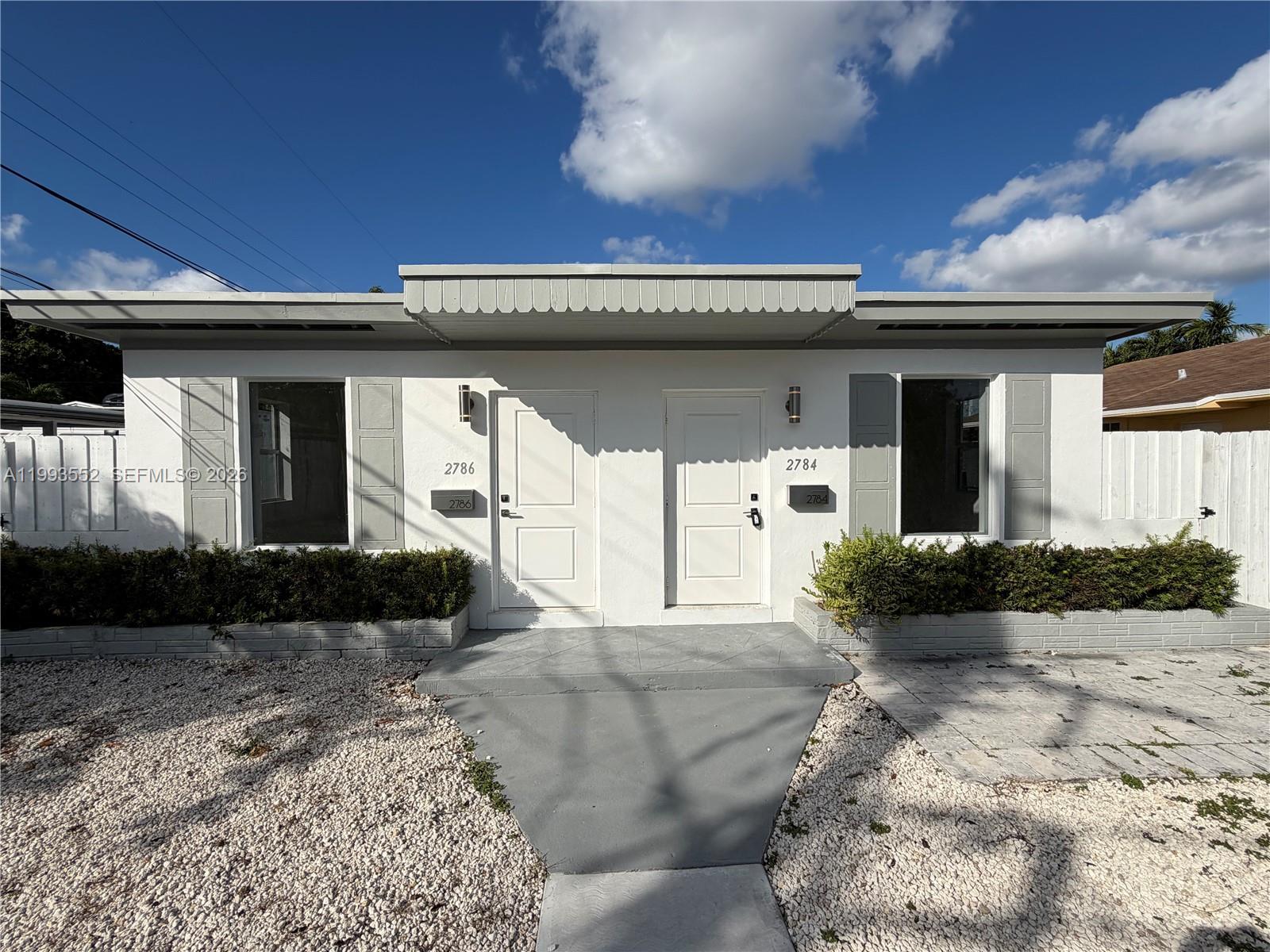 2784 Southwest 31st Place Miami, FL 33133 - Photo 3 of 16 a front view of a house with garden