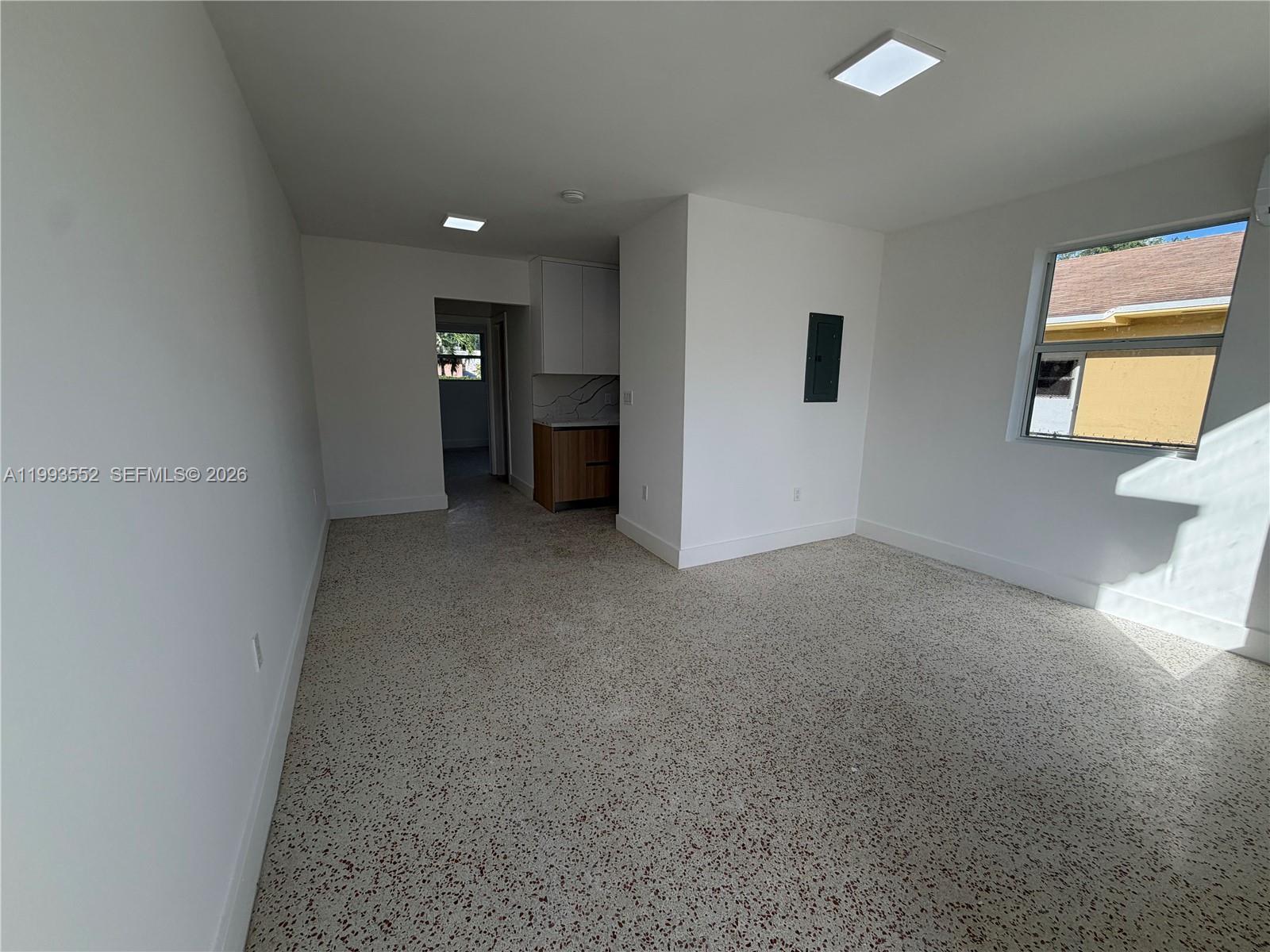 2784 Southwest 31st Place Miami, FL 33133 - Photo 4 of 16 an empty room with windows and cabinet