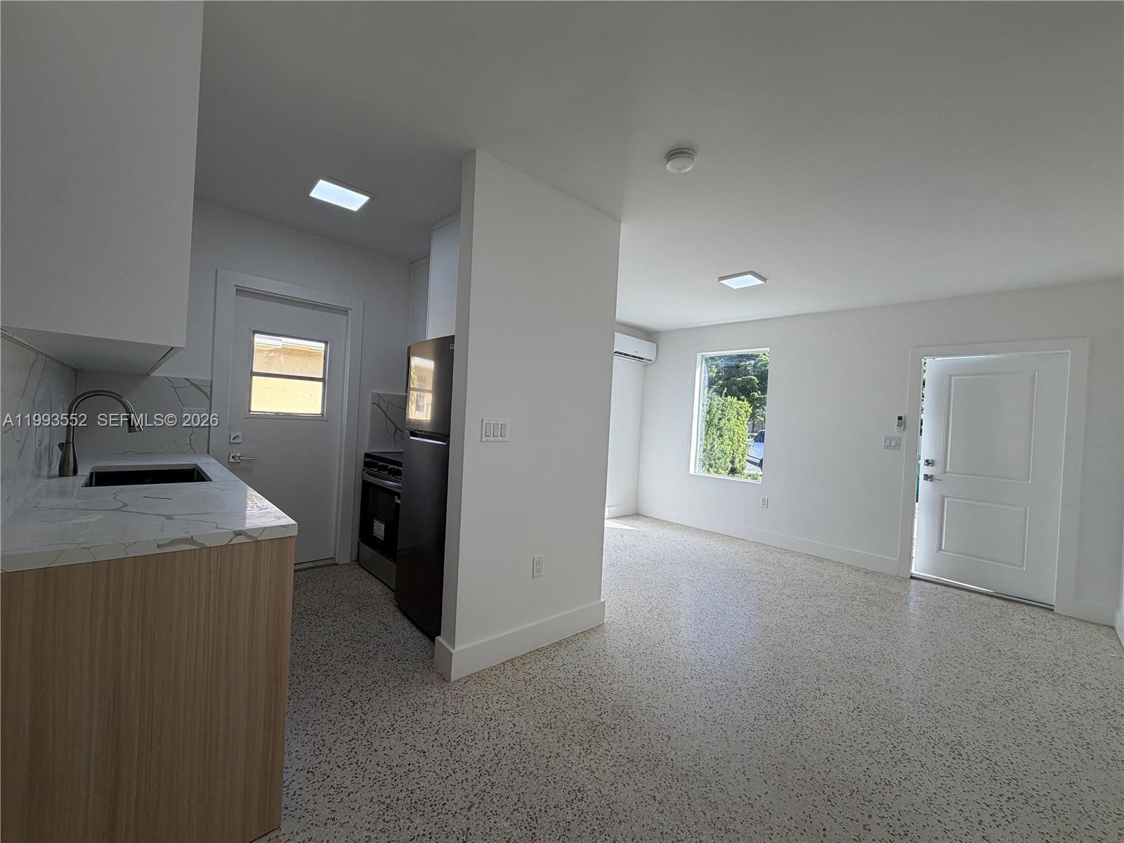 2784 Southwest 31st Place Miami, FL 33133 - Photo 7 of 16 a view of a kitchen cabinets and a livingroom