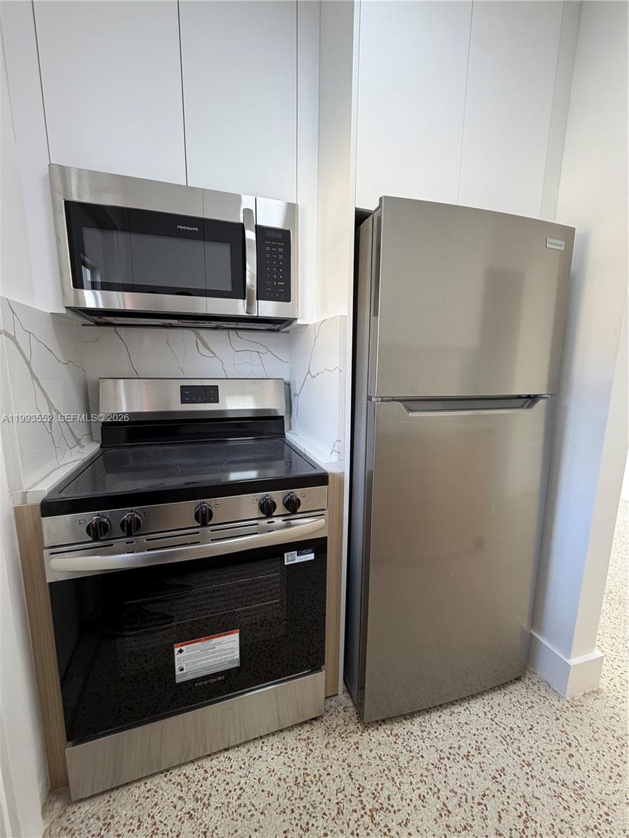 2784 Southwest 31st Place Miami, FL 33133 - Photo 8 of 16 a stove top oven sitting inside of a kitchen