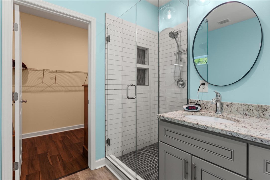 67 Sawblade Ridge Marietta, SC 29661 - Photo 20 of 37 Granite counters and a tiled walk-in shower elevate this modern bathroom setting.