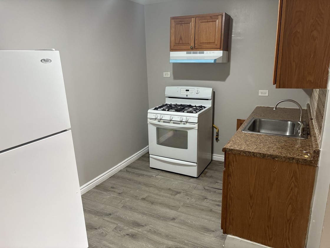 1930 South Cicero Avenue, Unit 208 Cicero, IL 60804 - Photo 4 of 9 a kitchen with a refrigerator sink and stove