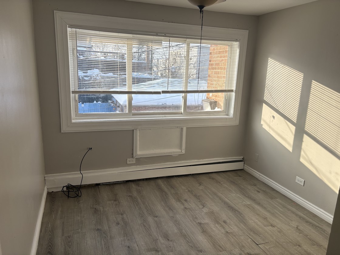 1930 South Cicero Avenue, Unit 208 Cicero, IL 60804 - Photo 6 of 9 a view of an empty room with wooden floor and a window