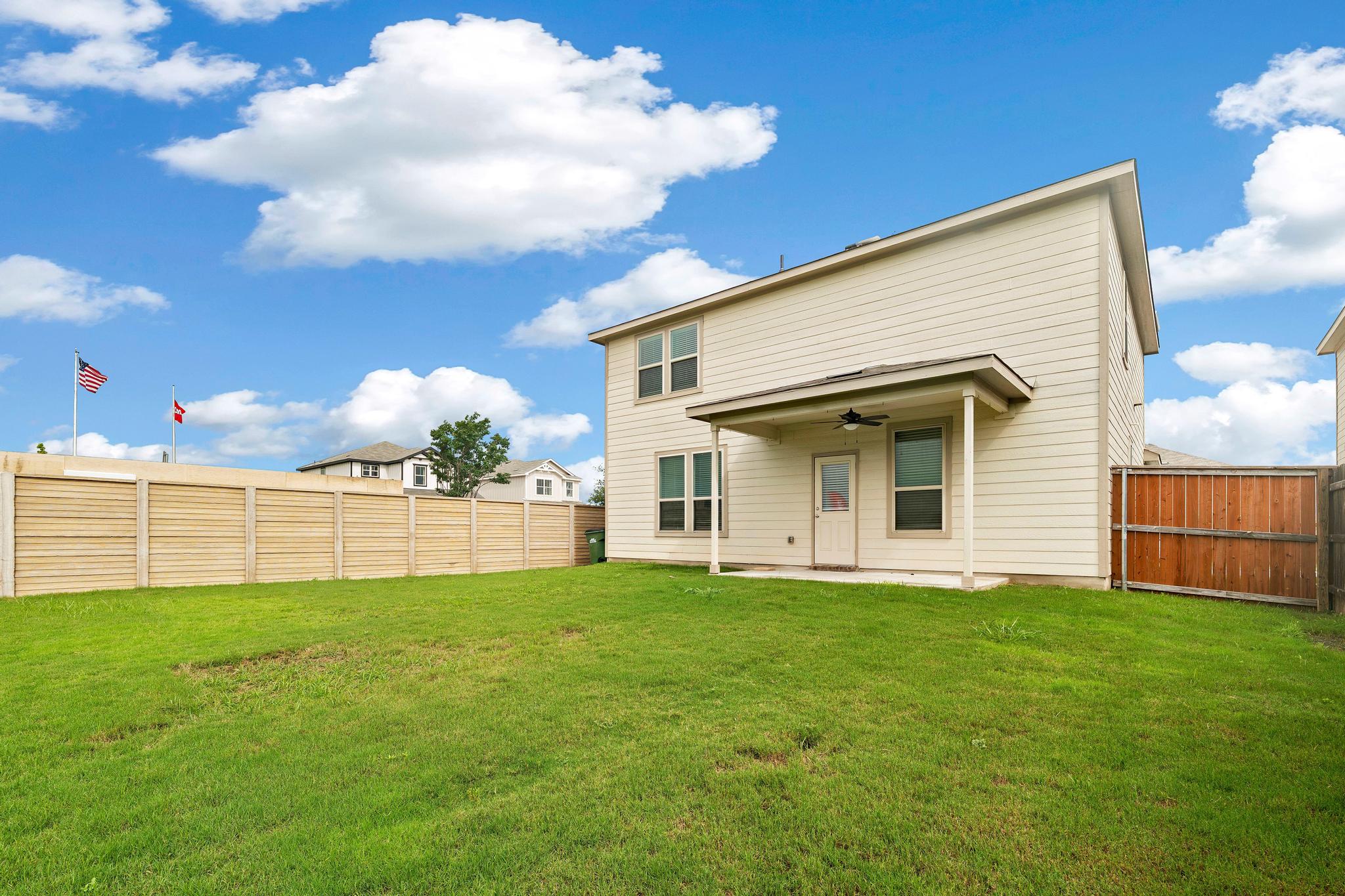 217 Innisfree Road Jarrell, TX 76537 - Photo 34 of 39 A verdant backyard retreat featuring a covered patio, perfect for outdoor relaxation and entertaining.