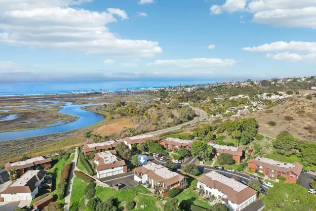 an aerial view of residential houses with outdoor space