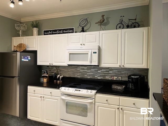 450 Park Avenue, Unit 112 Foley, AL 36535 - Photo 9 of 20 Kitchen with new refrigerator and dishwasher, dark countertops, tasteful backsplash, white cabinets, and crown molding
