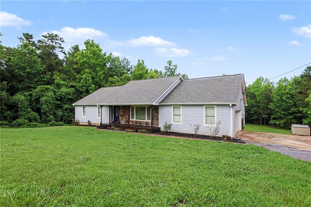 7388 Post Road Winston, GA 30187 - Photo 2 of 32 a view of a house with a big yard plants and large trees