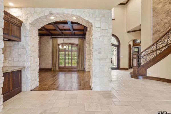 a living room with furniture a fireplace and a floor to ceiling window