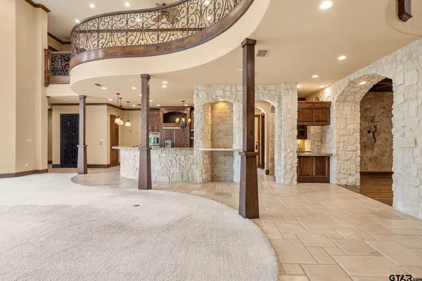 a kitchen with stainless steel appliances granite countertop a sink a stove and a refrigerator