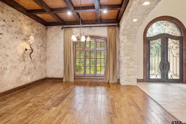 a view of a hallway with a living room and stainless steel appliances