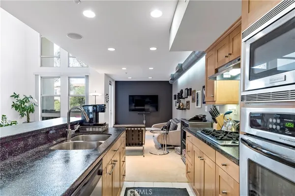 a kitchen with stainless steel appliances granite countertop sink stove and cabinets