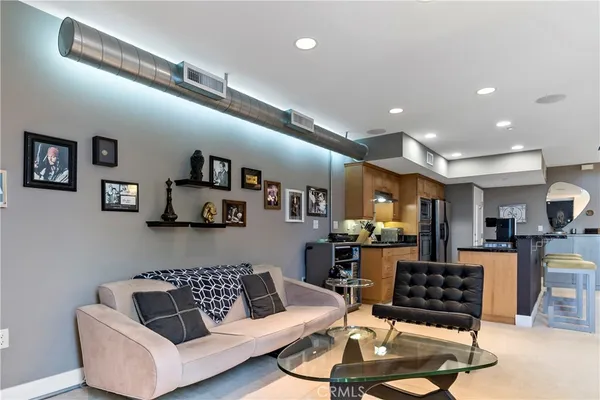 a living room with furniture and kitchen view