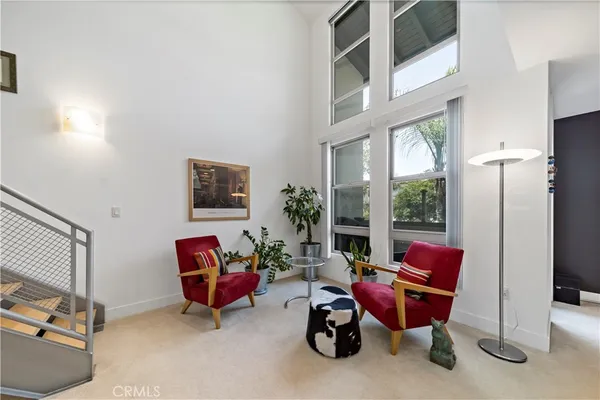 a living room with furniture a rug and a window