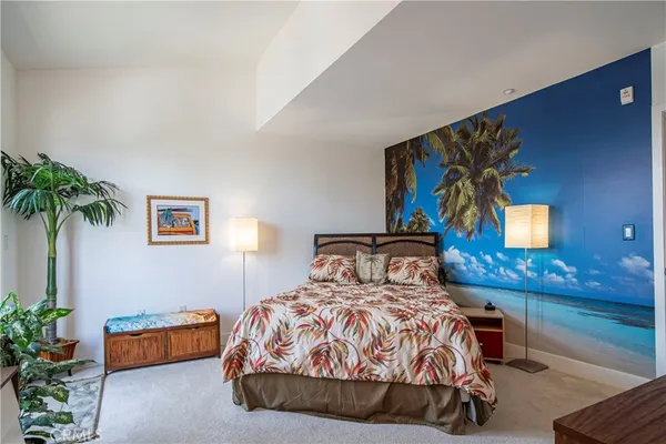a bedroom with a bed and a potted plant