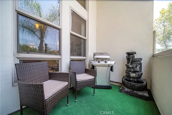 a living room with furniture a rug and a window