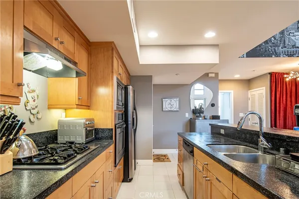 a kitchen with a sink stove and cabinets
