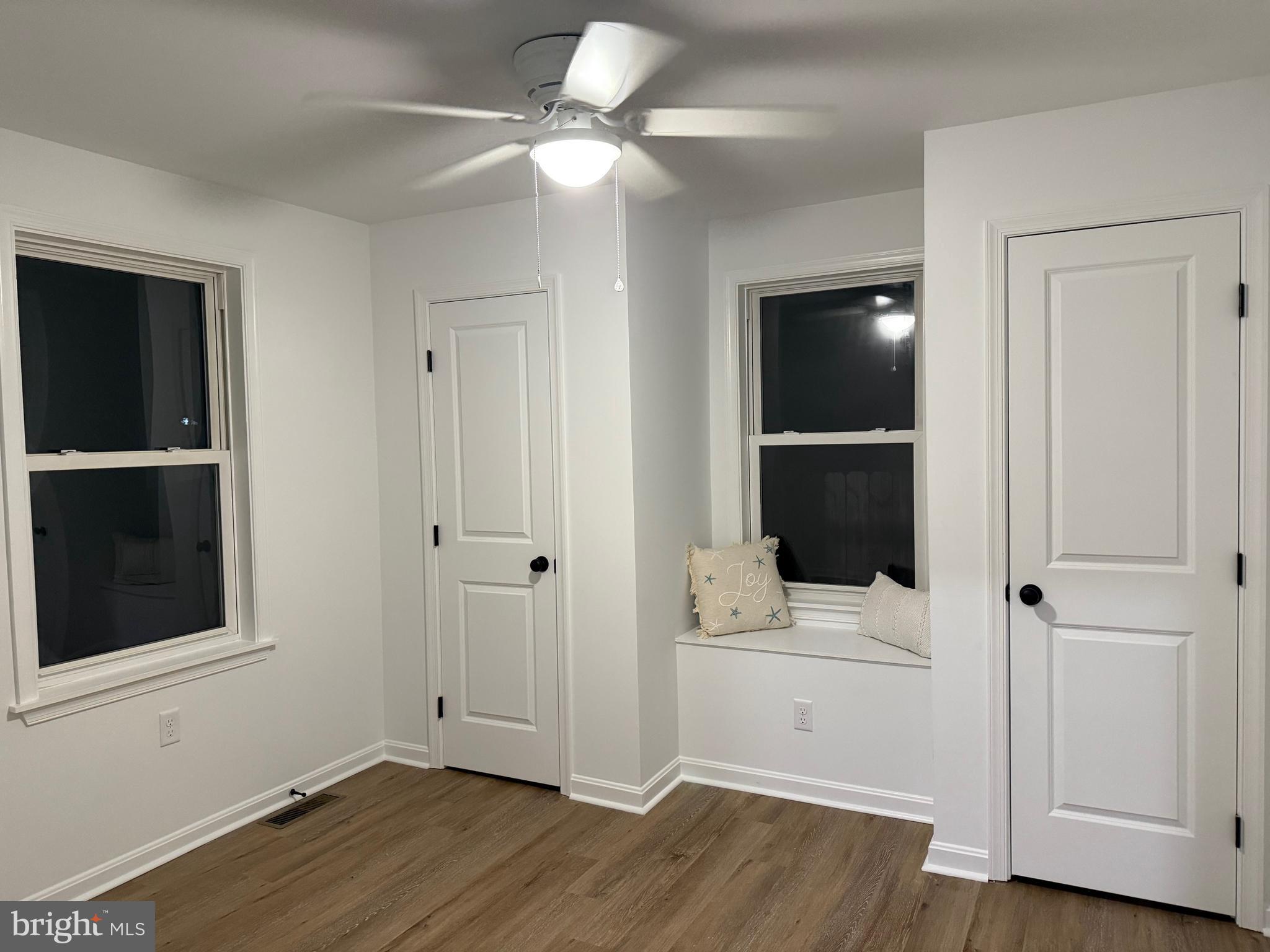 972 South Little Creek Road Dover, DE 19901 - Photo 11 of 22 an empty room with wooden floor and cabinet
