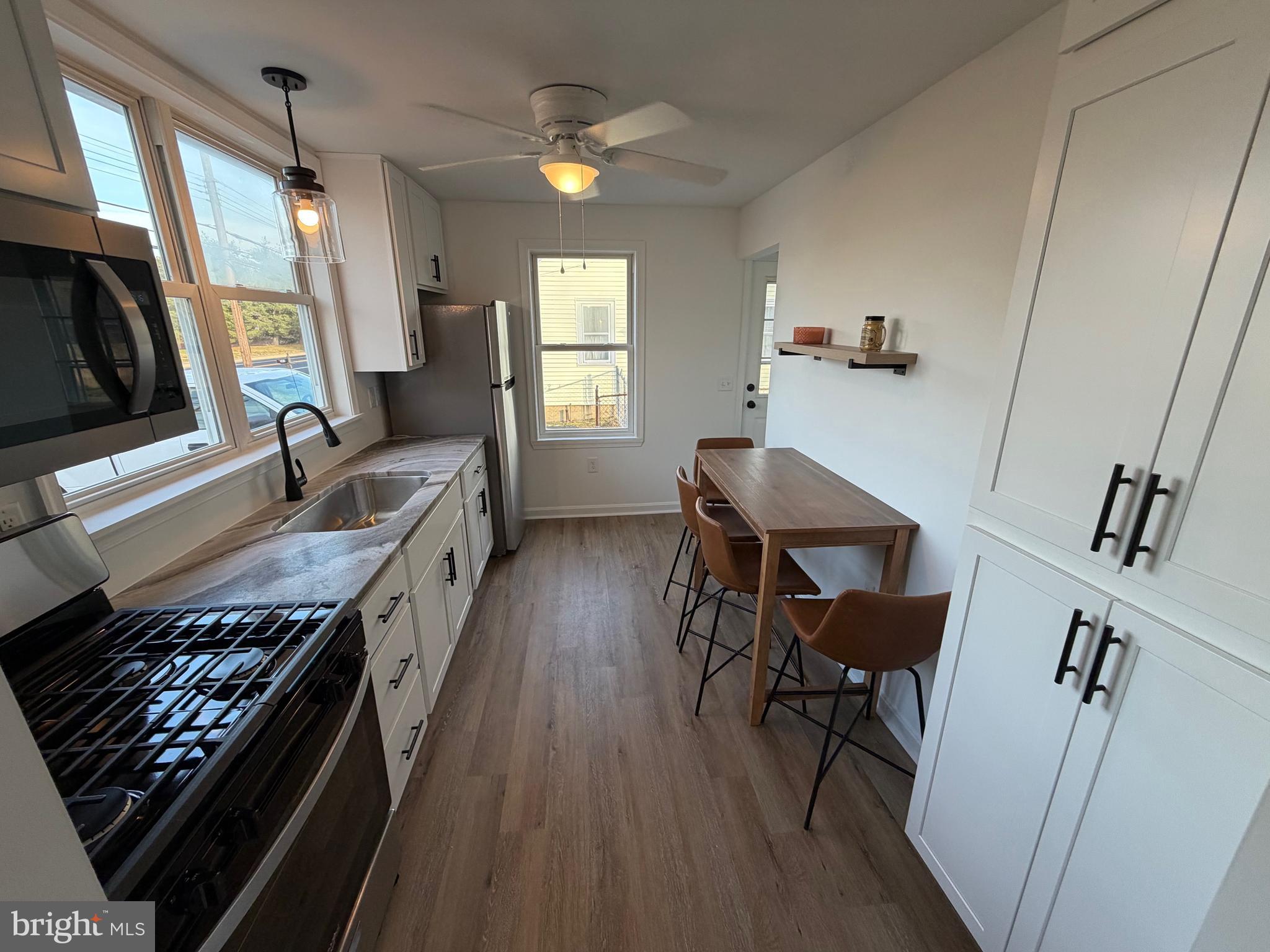 972 South Little Creek Road Dover, DE 19901 - Photo 7 of 22 a kitchen with sink stove and wooden floor