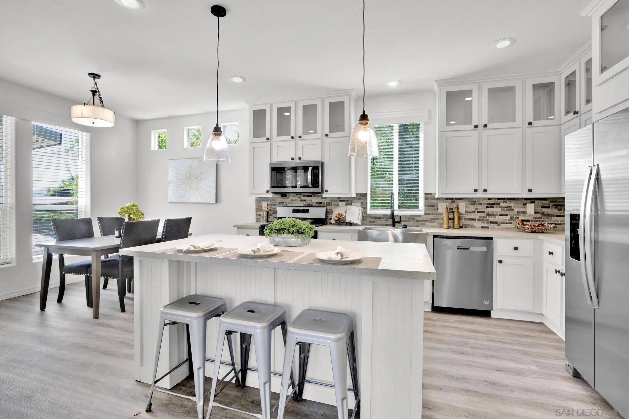 1120 Pepper Drive, Unit 183 El Cajon, CA 92021 - Photo 5 of 21 a kitchen with refrigerator a stove and white cabinets