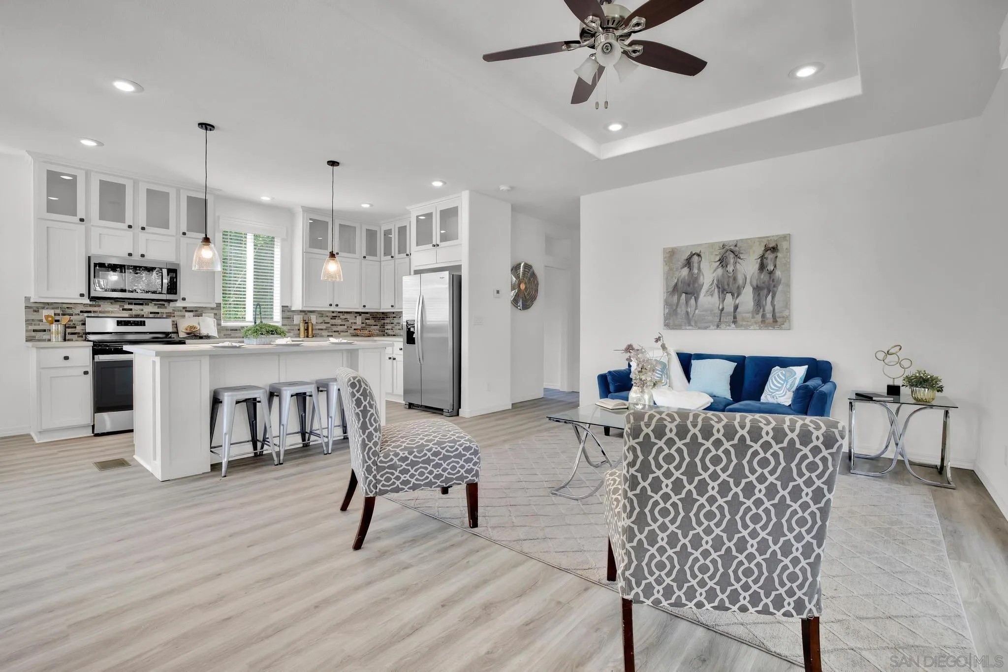 1120 Pepper Drive, Unit 183 El Cajon, CA 92021 - Photo 9 of 21 a living room with stainless steel appliances furniture a dining table and a chandelier