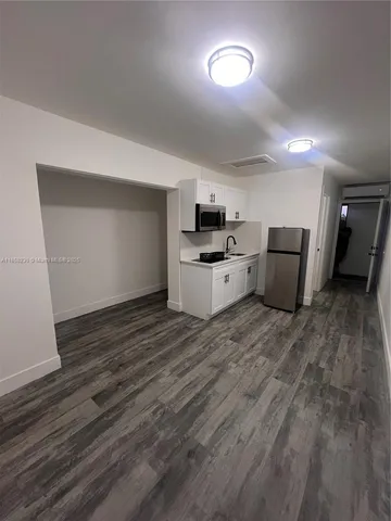 a view of a kitchen with a sink and a stove top oven