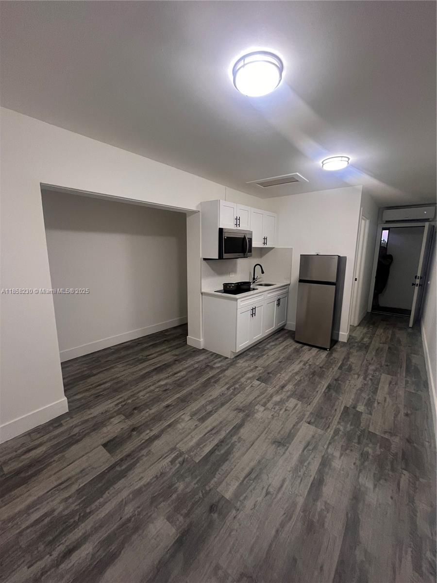 a view of a kitchen with a sink and a stove top oven