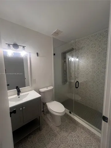a bathroom with a double vanity sink toilet and shower