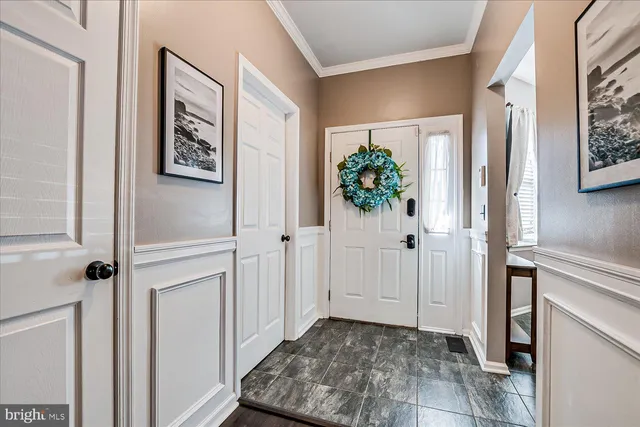 a view of a hallway with wooden floor and a plant