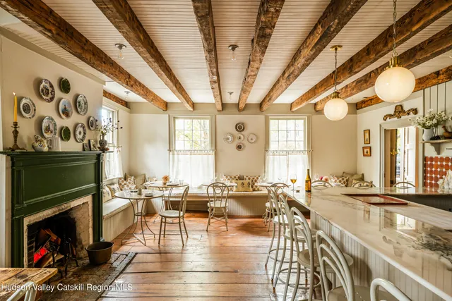 a dining room with furniture a rug and wooden floor