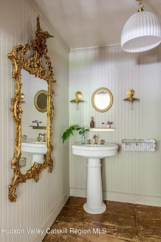 a view of a hallway with wooden floor and windows