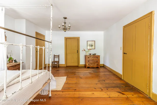 a view of a house with a small yard and wooden floor and fence