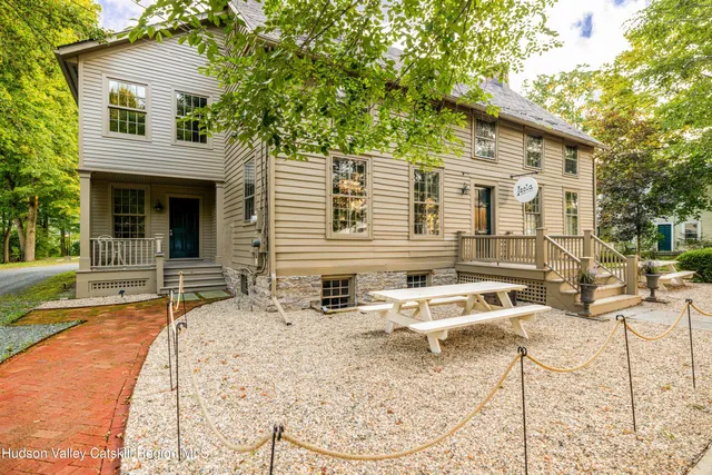 a backyard of a house with yard and outdoor seating
